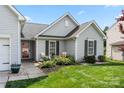 Charming single-story home featuring a well-manicured lawn and a welcoming front porch area at 114 Nevis Ln, Mooresville, NC 28115