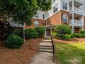 Entrance to building with well-manicured landscaping and a paved walkway and steps at 11530 Costigan Ln, Charlotte, NC 28277