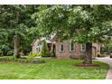 Beautifully landscaped home with a lush lawn and mature trees at 12900 Westmoreland Rd, Huntersville, NC 28078