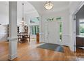Bright entryway with hardwood floors, high ceilings, and adjacent dining area at 12900 Westmoreland Rd, Huntersville, NC 28078