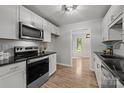 Well-lit kitchen with stainless steel appliances, sleek countertops, and light wood floors at 13446 Idlefield Ln, Matthews, NC 28105