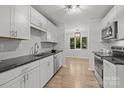 Bright kitchen featuring modern appliances, white cabinetry, and hardwood floors at 13446 Idlefield Ln, Matthews, NC 28105