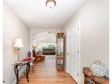 Inviting foyer with wood flooring and elegant decor leading to the living area at 13830 Riding Hill Ave, Charlotte, NC 28213