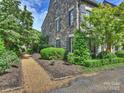 Beautiful townhome featuring manicured landscaping and a stone facade at 1522 High St, Charlotte, NC 28211