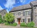 Charming stone townhome featuring beautiful landscaping and a private entrance at 1522 High St, Charlotte, NC 28211