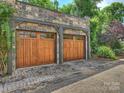 Spacious detached two-car garage featuring two wooden doors and ample parking at 1522 High St, Charlotte, NC 28211