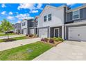 Attractive townhomes with tidy landscaping, attached garages, and convenient front entrances at 1563 Old Rivers Rd, Concord, NC 28027