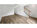 Spacious living room with hard wood floors, natural light, and staircase at 1908 Harvest Ln # 5, Charlotte, NC 28210