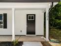 Close-up of the front door, showing modern design elements, house number, and a covered porch with support columns at 208 N Correll St, Landis, NC 28025