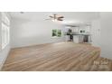 Open-concept living space combining the living room and kitchen with modern appliances and wood grain flooring at 208 N Correll St, Landis, NC 28025