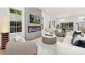 Sun-filled living room with a cozy fireplace, stylish decor, and an inviting atmosphere at 2414 E 7Th St, Charlotte, NC 28204