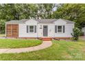Inviting home features a walkway leading to the front door and updated exterior finishes at 2601 Ashley Rd, Charlotte, NC 28208