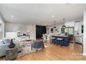 Open-concept design showcasing the living room, dining area, and kitchen with stainless steel appliances at 300 Dollar Cir, Charlotte, NC 28270