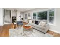 Cozy living room featuring a comfortable sofa, fireplace, and large bay window for natural light at 300 Dollar Cir, Charlotte, NC 28270