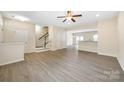 Bright living room with wood floors and staircase at 3039 Potomac River Pkwy, Charlotte, NC 28217