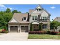 Charming two-story home with a three car garage and beautiful stone and siding exterior at 4021 Redwood Ave, Charlotte, NC 28205