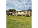 Well-kept single-story home with brick accents and a nicely landscaped front yard at 403 Kings Dr, Cherryville, NC 28021