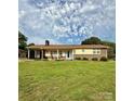 Inviting single-story home featuring a brick facade and a spacious green lawn at 403 Kings Dr, Cherryville, NC 28021