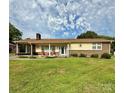 Inviting single-story home featuring a brick facade and a spacious green lawn at 403 Kings Dr, Cherryville, NC 28021