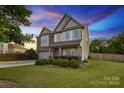Charming two-story home with a manicured lawn, a two-car garage, and a combination of brick and siding at 4430 Bravery Sw Pl, Concord, NC 28027