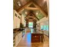 Gourmet kitchen with a large island, a wood beam vaulted ceiling, and modern appliances at 5016 Carolina North Dr, Gastonia, NC 28056