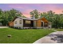 Charming single-Gathering home with green lawn, modern accents and neutral paint, set in a serene, wooded landscape at 5033 Waxhaw Indian Trail Rd, Matthews, NC 28104