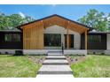 Beautiful front entrance of home with modern wood details and walkway at 5033 Waxhaw Indian Trail Rd, Matthews, NC 28104
