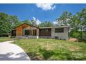 Stunning home featuring modern architectural design and lush green lawn at 5033 Waxhaw Indian Trail Rd, Matthews, NC 28104