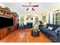 Bright living room with a fireplace, hardwood floors, and ample seating at 530 Shady Oaks Dr, Stanley, NC 28164