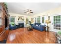 Open living room area features hardwood floors, a fireplace, large windows, and access to the dining room and a view to the backyard at 530 Shady Oaks Dr, Stanley, NC 28164