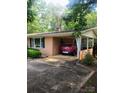 Brick ranch home with a covered carport, mature shrubs, and lush, green lawn at 536 Catalina Dr, Albemarle, NC 28001