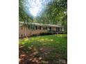 Charming brick ranch home with mature trees, manicured lawn, and covered entryway at 536 Catalina Dr, Albemarle, NC 28001