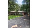 Charming brick ranch home featuring a covered carport, manicured lawn, and mature trees at 536 Catalina Dr, Albemarle, NC 28001