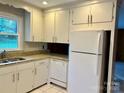 Functional kitchen with white cabinets, granite countertops, and modern appliances at 5734 Brookhaven Rd, Charlotte, NC 28210