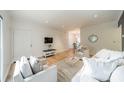 Comfortable living room with light wood flooring and plush seating, complemented by a dining area in view at 5927 Quail Hollow Rd # H, Charlotte, NC 28210