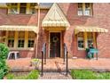 Close-up of a brick Tudor-style home's front door, showcasing architectural details at 611 E Marion St, Shelby, NC 28150