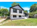 Two-story home featuring modern black window accents, a manicured lawn and partially fenced yard at 6328 Beecher Dr, Charlotte, NC 28215