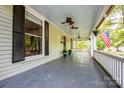 Relaxing covered front porch with ceiling fans, perfect for enjoying the outdoors at 636 N Center St, Statesville, NC 28677