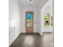 Inviting entryway with hardwood floors and a wood-framed glass front door to let the light in at 6782 Kingfisher Ct, Denver, NC 28037