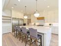 Spacious modern kitchen featuring a large island, stainless steel appliances, and pendant lighting at 7209 Alexander Rd # 3, Charlotte, NC 28270