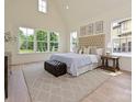 Serene main bedroom with plenty of natural light, a tufted headboard, and neutral tones at 7209 Alexander Rd # 3, Charlotte, NC 28270