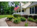 Beautiful front yard featuring flower beds, green bushes, a sidewalk, and a charming home with a welcoming porch at 785 Sanside Dr, York, SC 29745
