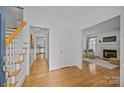 Bright foyer with hardwood floors and staircase leading to the second floor at 8441 Sandowne Ln, Huntersville, NC 28078