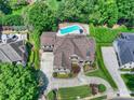Sprawling property boasts a private backyard oasis with a sparkling pool, lush landscaping, and mature trees at 9104 Kingsmead Ln, Waxhaw, NC 28173