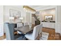 Elegant dining room with a stunning chandelier, hardwood floors, and stylish furnishings at 9104 Kingsmead Ln, Waxhaw, NC 28173
