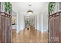 Elegant foyer features hardwood floors, chandelier, and decorative molding at 9104 Kingsmead Ln, Waxhaw, NC 28173