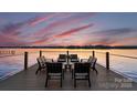 Outdoor seating on a wooden dock overlooking water with amazing sunset views at 138 Lakefront Dr, Mooresville, NC 28117