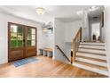 Bright foyer featuring wood floors, stairs, and a conveniently placed coat rack at 138 Lakefront Dr, Mooresville, NC 28117