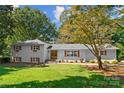 Charming home with a well-manicured lawn, mature trees, and great curb appeal at 138 Lakefront Dr, Mooresville, NC 28117