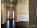 Inviting foyer with hardwood floors and decorative molding, leading to the main living area at 147 Dubois Dr, Mooresville, NC 28115